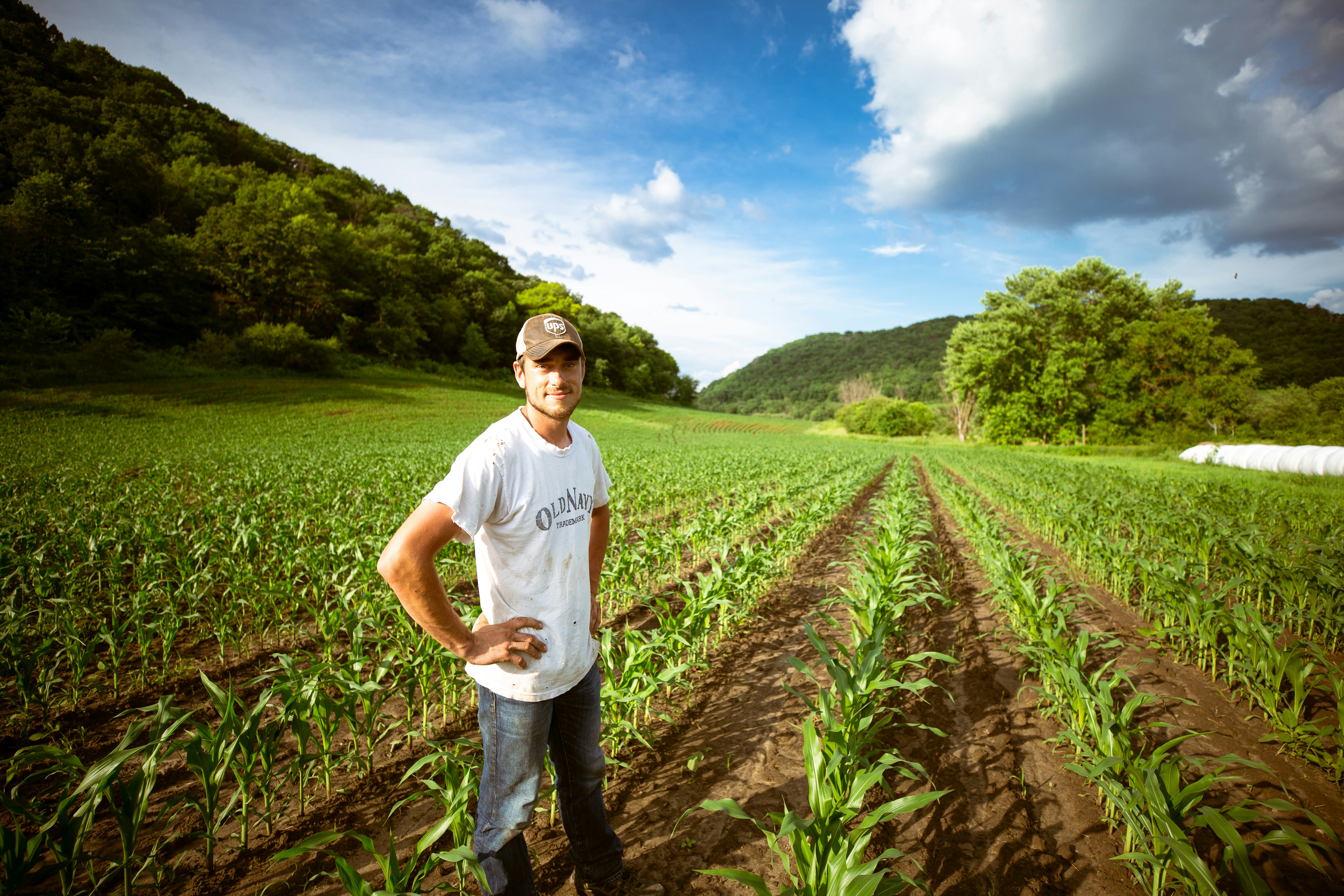 A farmer looking at his crops proudly